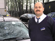 Train Manager CG Papa outside Hampstead Heath railway station 