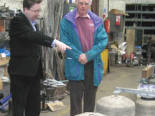 John Thorp (right) and Matthew Power, church warden of St Anne's, inspecting the cracked bells of the Whitechapel bell foundry 