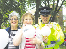 Peggy Kirk and Mary Holtby with Highgate and Haringey PC Darren Warren   