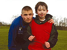 Arsenal community coach Alex Perfect helps John keep active