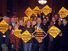 Newly elected Lib Dem councillor Nick Russell (centre, blue shirt) celebrates at the Town Hall 