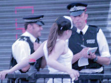 Police officers carry out a 'stop and search' while on patrol in Camden Town