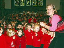 Musical director Gitika Partington with children from Christ Church School