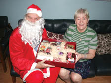 Santa 'Courtney O'Connor' Claus presents a hamper to Bridget Crowley