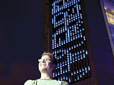   Michael Brown with his artwork Bluerain, which will display titles of books being checked in and out of the university library 