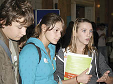 Acland Burghley pupils (left to right) Luke Woollard, 14, Sonia Paganuzzi, 15, and Hattie Brock, 15, get in some early questions before the great inquisition proper starts in Camden’s Council Chamber