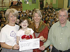 Naomi Angel of Great Ormond Street Hospital, left, receives the cheque from pupil Vicky Cole, Imogen Sharp from the school’s parent teacher association, and Gospel Oak headteacher Alan Seymour