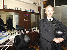 Sgt Chris Walsh with bags of drugs found inside the Firm Cut shop