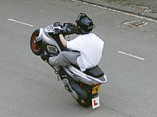 Youngster outside the motorbike workshop