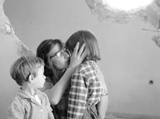 Children being comforted after a mortar attack 