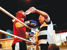 One of the All Stars coaches in the corner of one of the club's young boxers