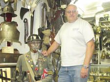 Chris Greenaway with a mannequin wearing a uniform and army buttons. 