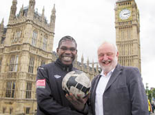 Homeless footballer Eric Mvale with his MP Frank Dobson outside the Houses of Parliament 